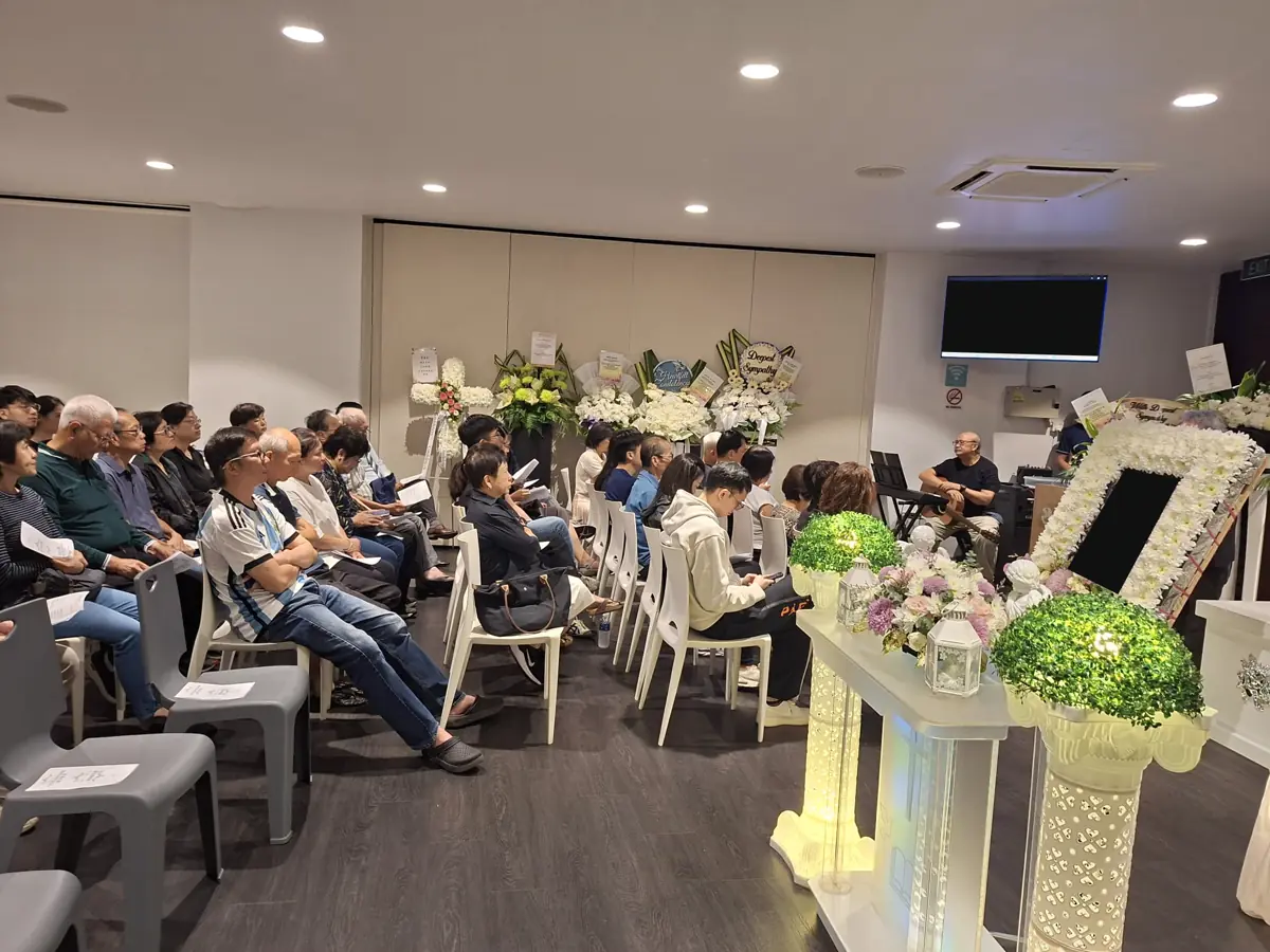 A funeral service in a church in Singapore, with the congregation seated