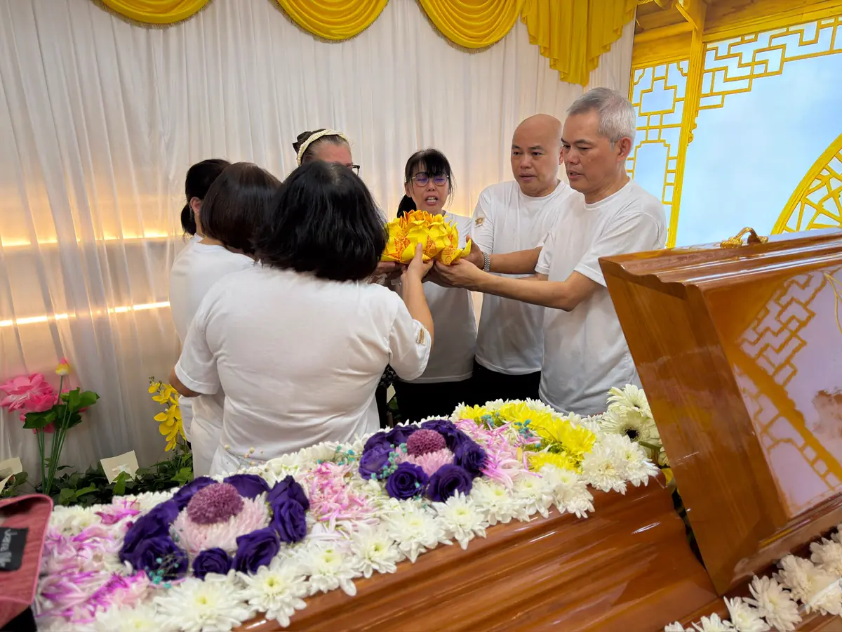 A family paying respects at a Wake in Singapore