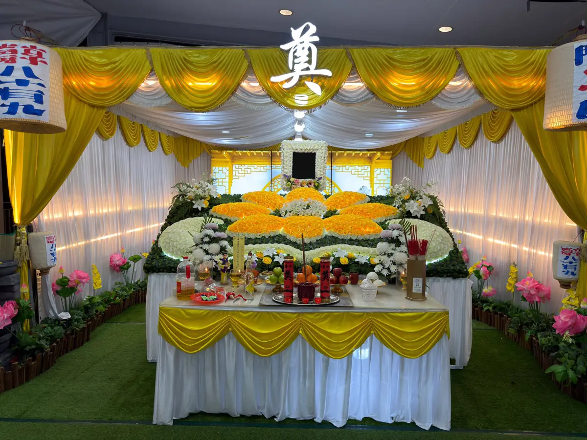 A Wake setup with a cross, altar and floral arrangement in Singapore