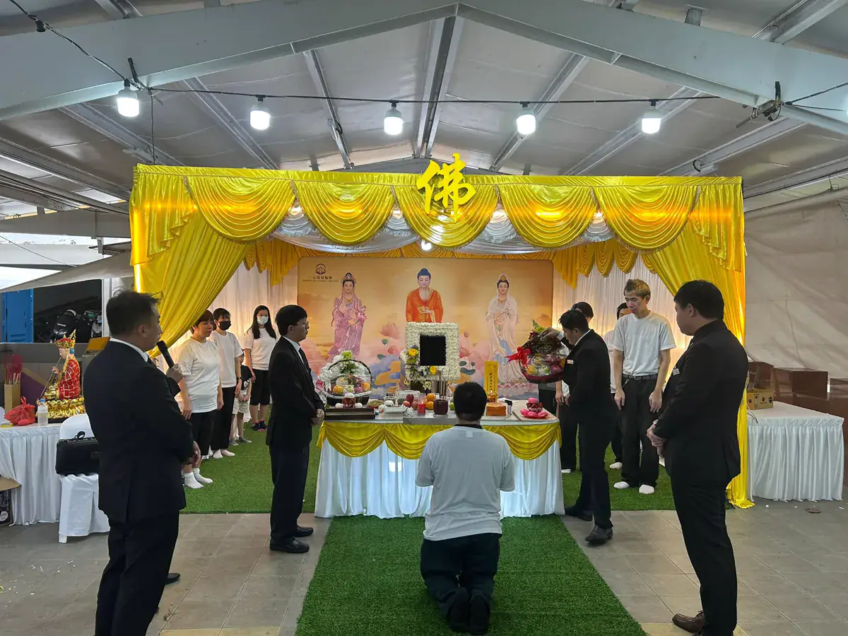 Monks chanting beside the deceased during the assisted-chanting period at a Buddhist wake