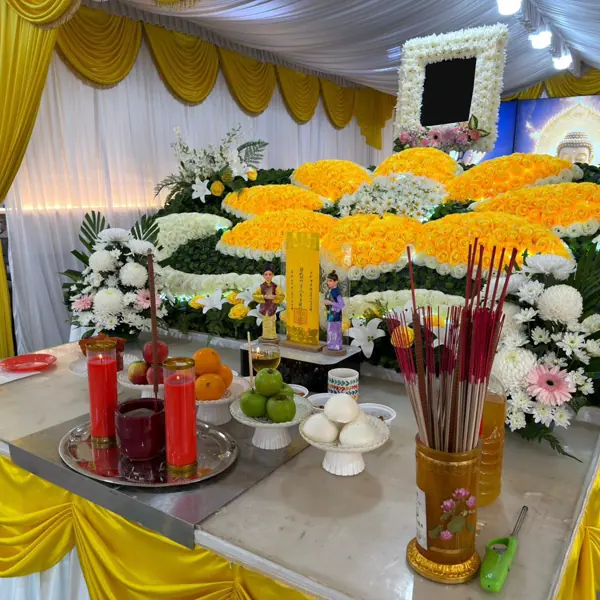 Floral tributes and offerings arranged at a funeral altar