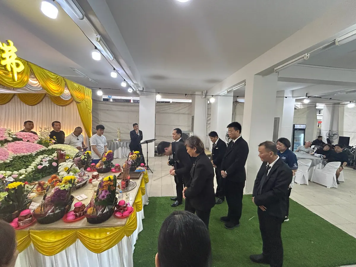 Family and guests gathered at a Buddhist wake in the evening