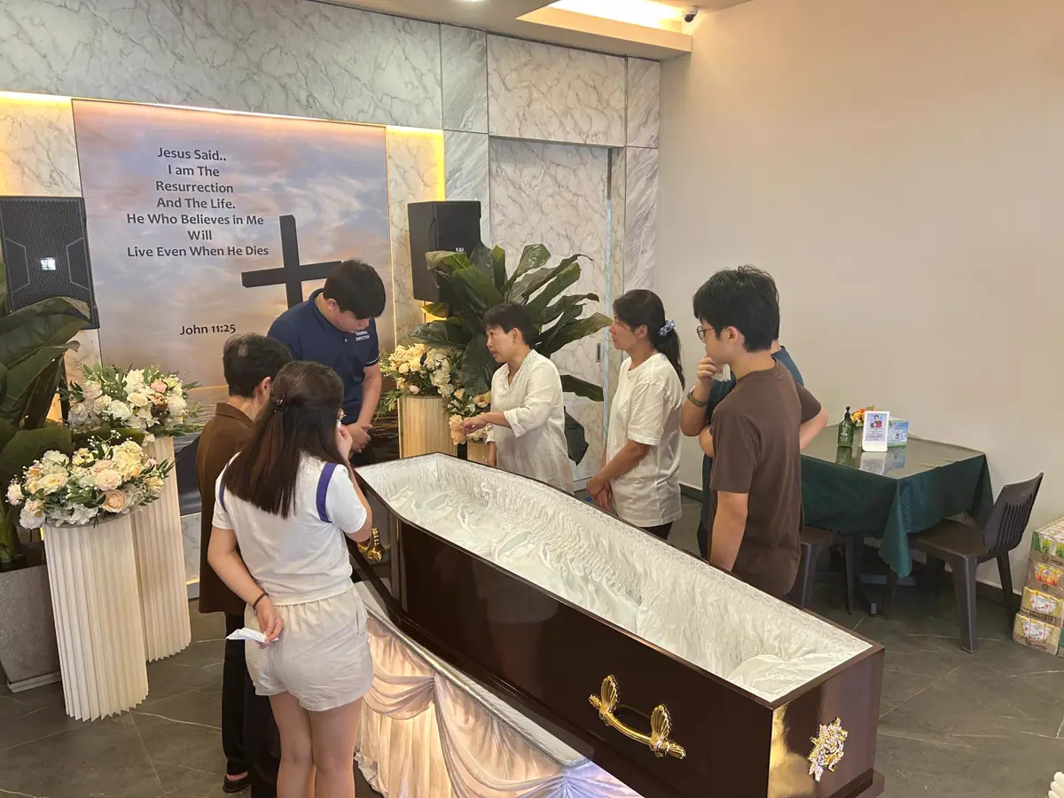 A condolence book at a Catholic wake in Singapore