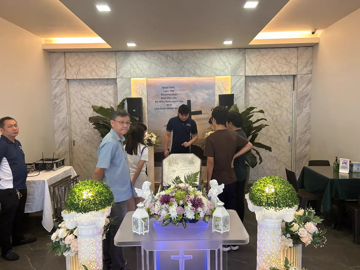 Pallbearers carrying a casket at a Catholic funeral in Singapore