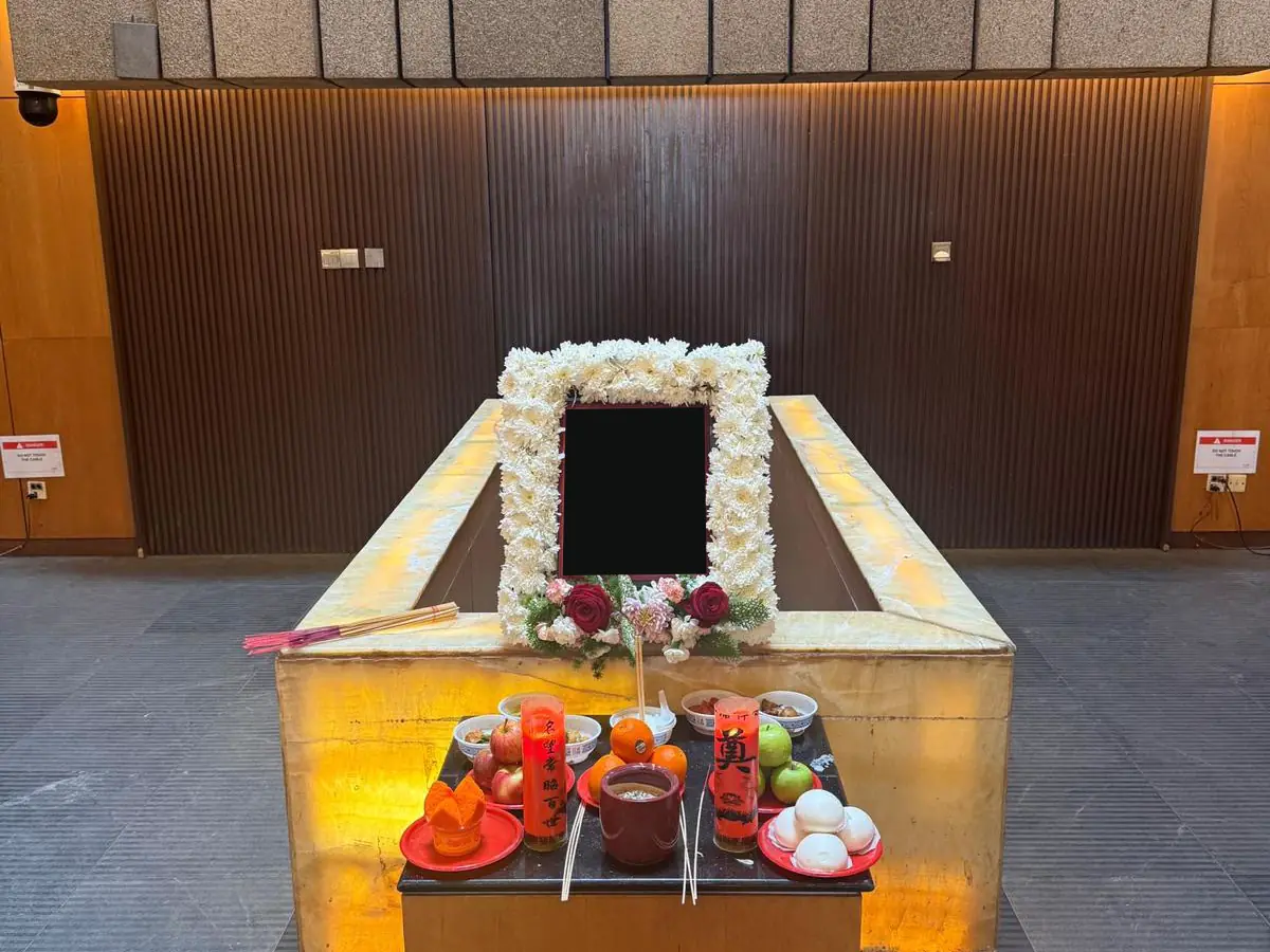 A Wake setup with a cross, altar and floral arrangement in Singapore