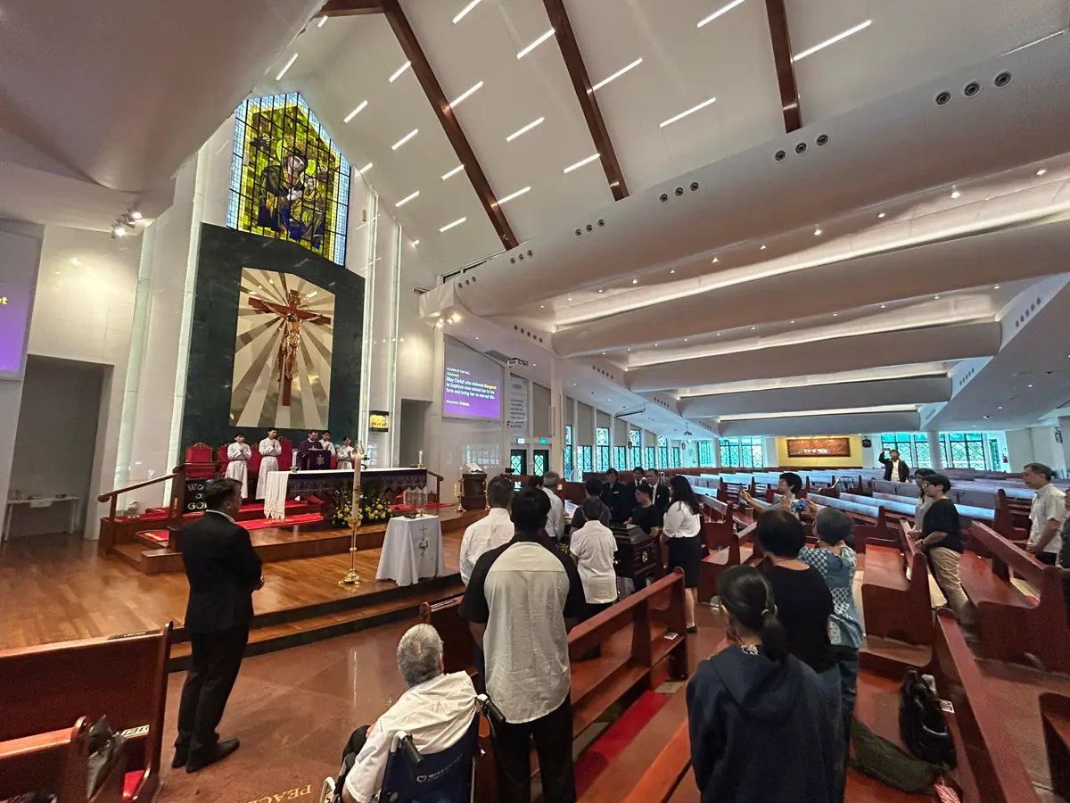 A Christian funeral service in a church in Singapore, with the congregation seated
