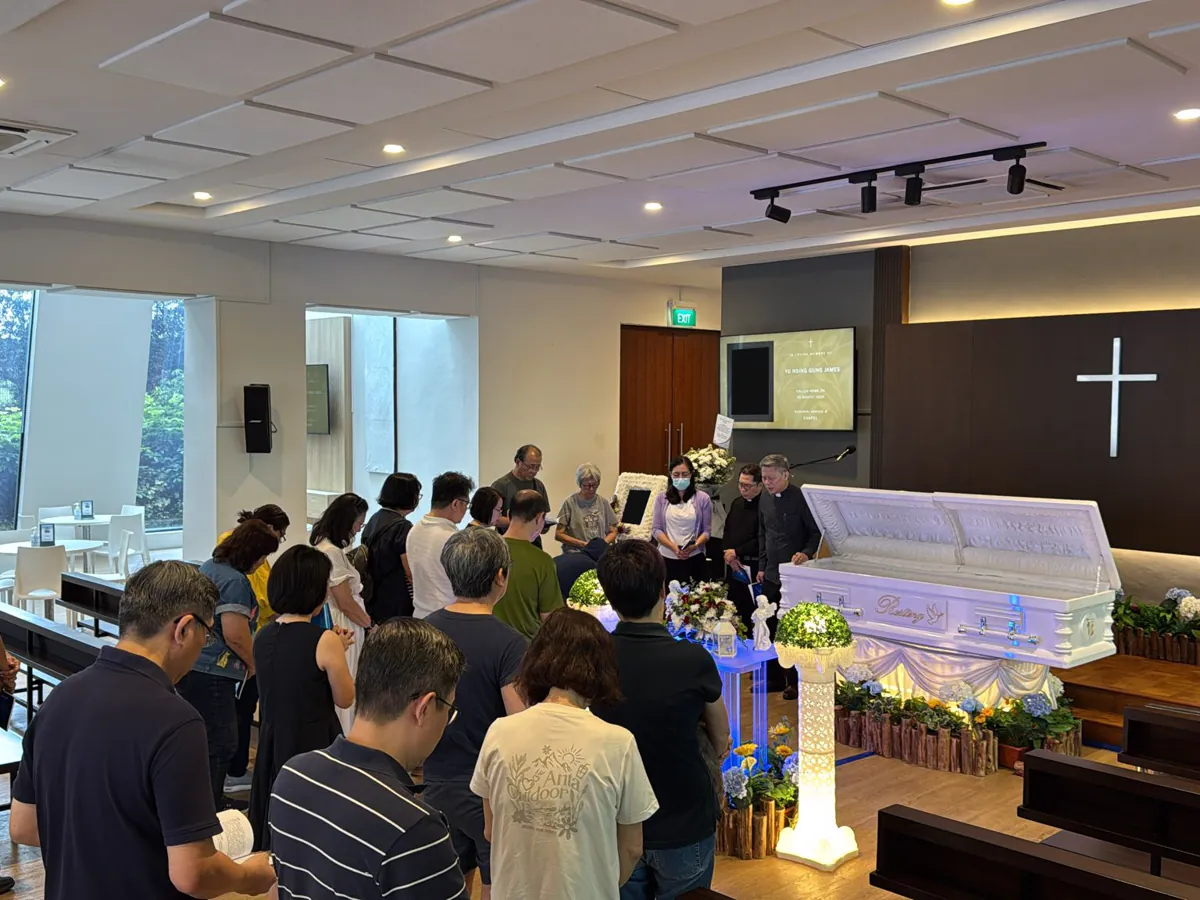 A family gathered for a funeral service in a chapel in Singapore