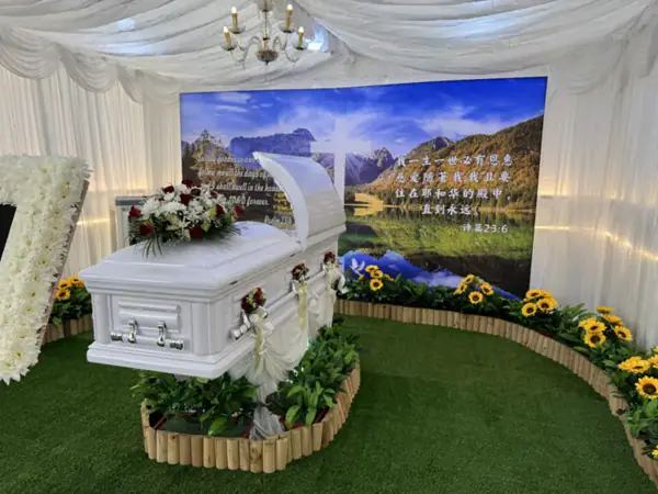 White casket with flowers at a Christian funeral