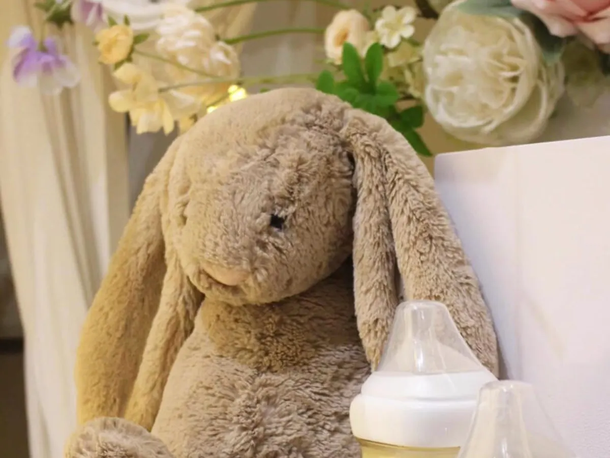 A soft toy and flowers prepared for an infant funeral service