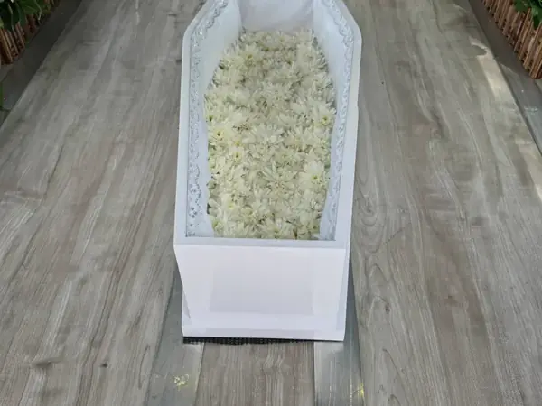 A small white casket prepared for an infant funeral