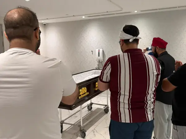 A family paying respects before repatriation