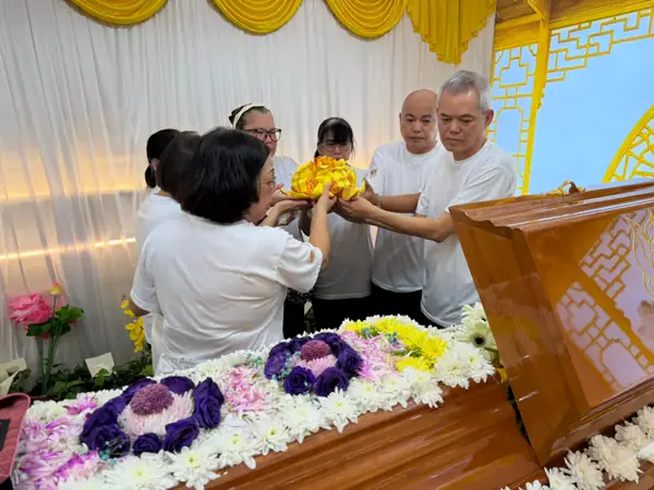 Family at the casket during a Taoist funeral