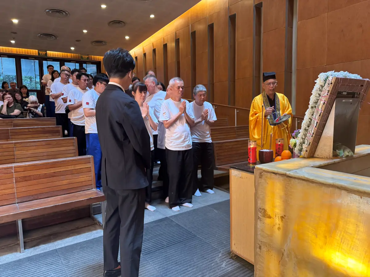 A Taoist funeral rite in Singapore, with the family gathered