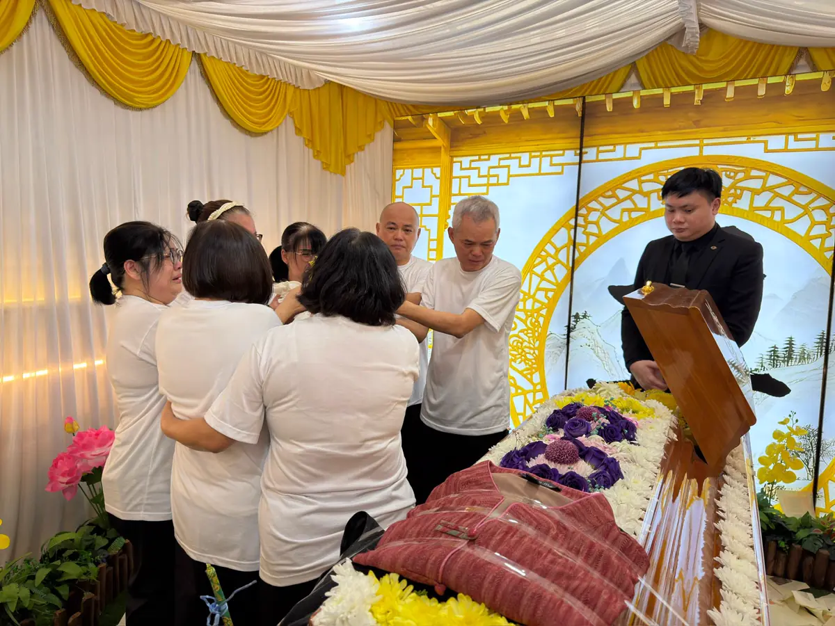 A family paying respects at a Taoist wake in Singapore